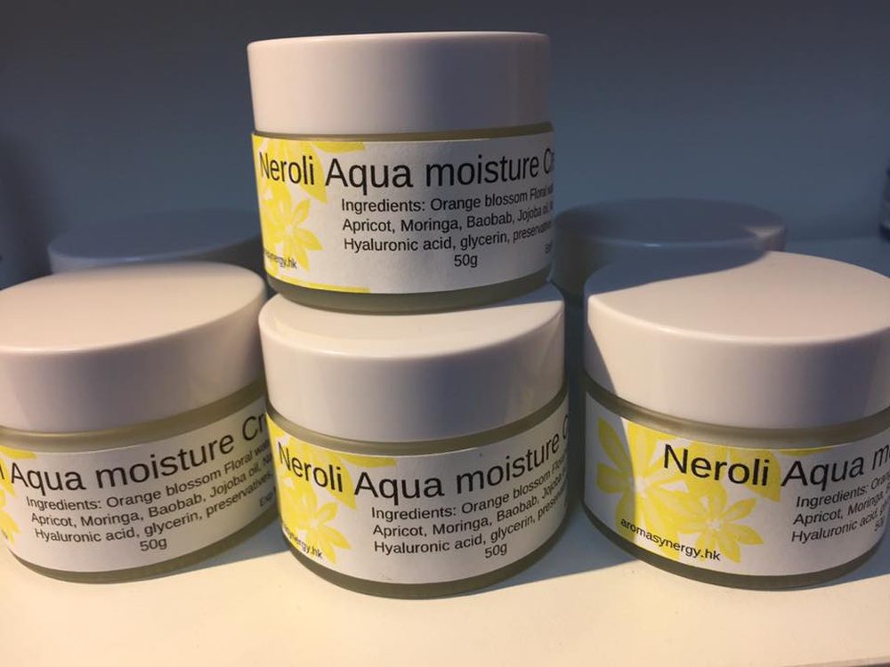 Jars of Neroli Aqua moisture creme with yellow floral labels