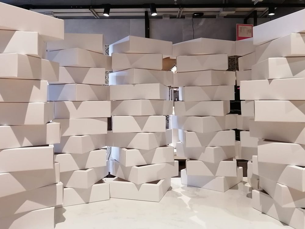 Stacked recyclable cardboard cartons waiting to be packed in the studio