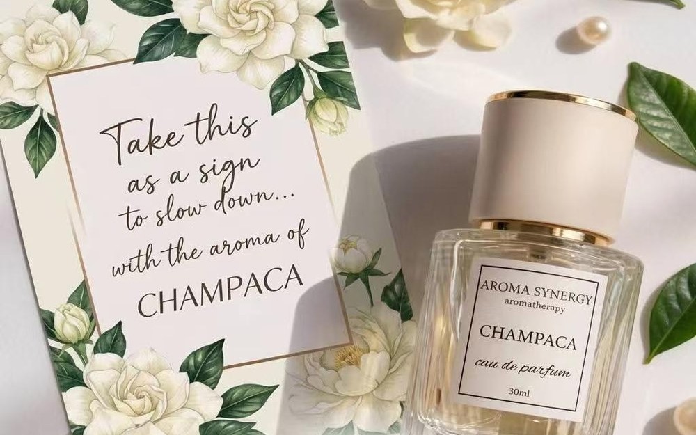 Champaca eau de parfum bottle surrounded by camellia blooms and a card reading Take this as a sign to slow down