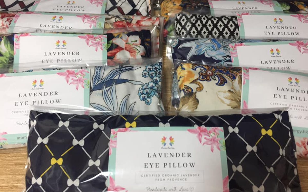 Stack of handmade lavender eye pillows in assorted floral fabrics
