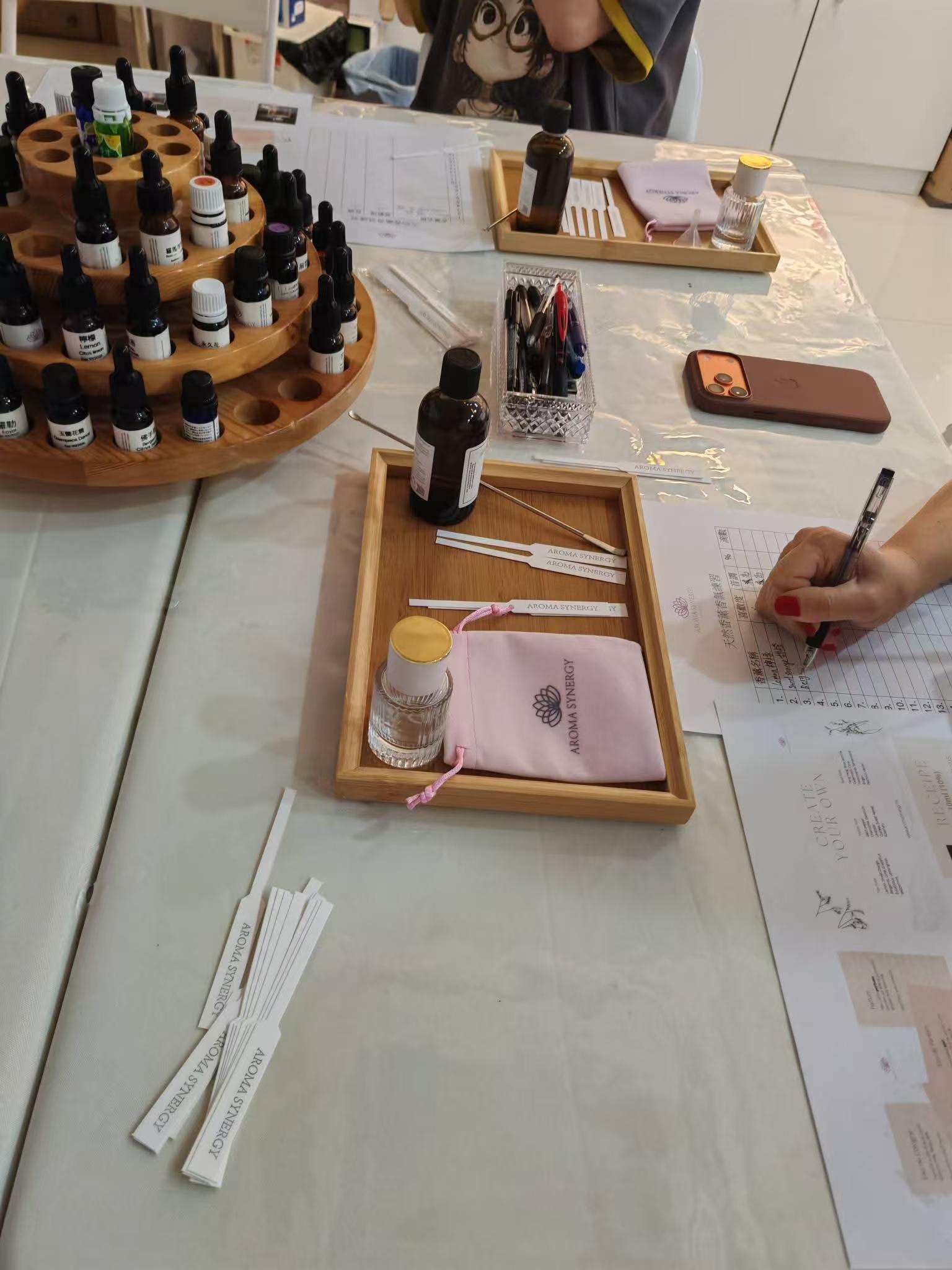DIY essential oil blending workshop — student scent-testing at the blending table in Hong Kong studio